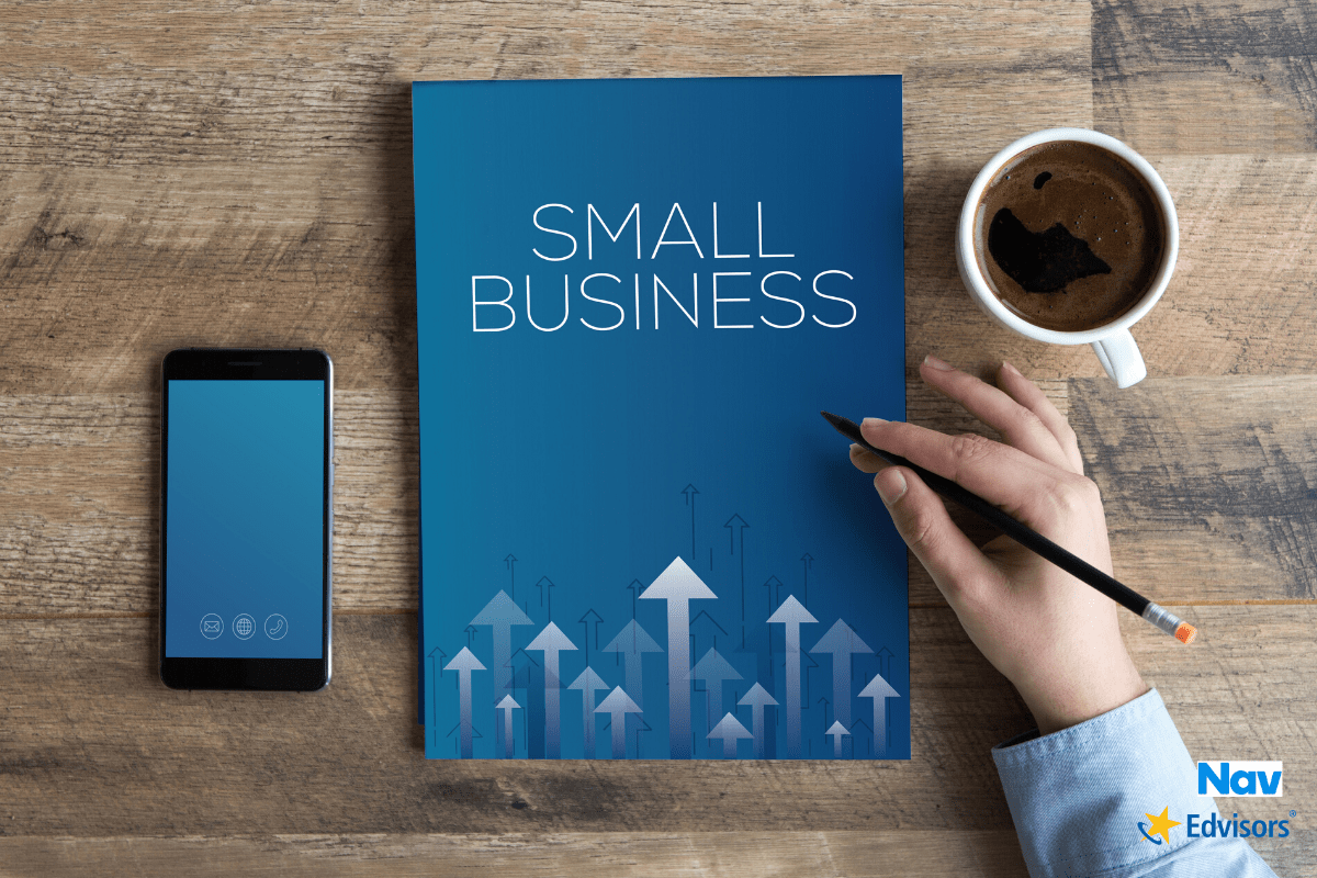 Phone and small business notebook on a table with coffee.