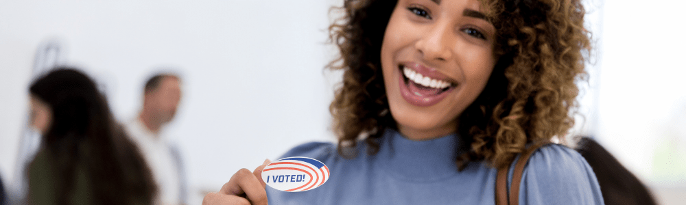 women smiling with I voted sticker 