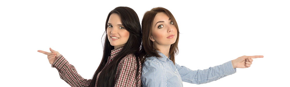 two girls back to back pointing in opposite directions