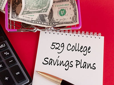 Notepad on desk with 529 College Savings Plans written on it