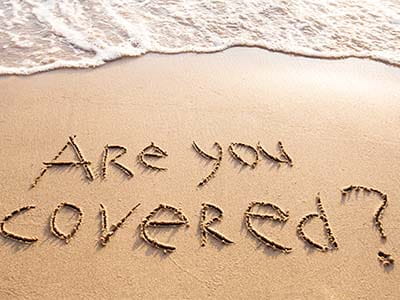 Risk Management - sand on beach with are you covered written in the sand