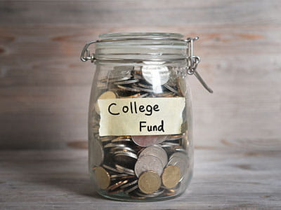 Jar labeled College Fund filled with coins