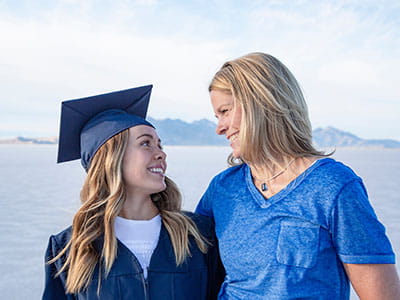 Graduate looking at her parent who will help her complete the FAFSA.