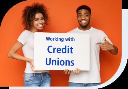 Two students holding a sign that says working with credit unions